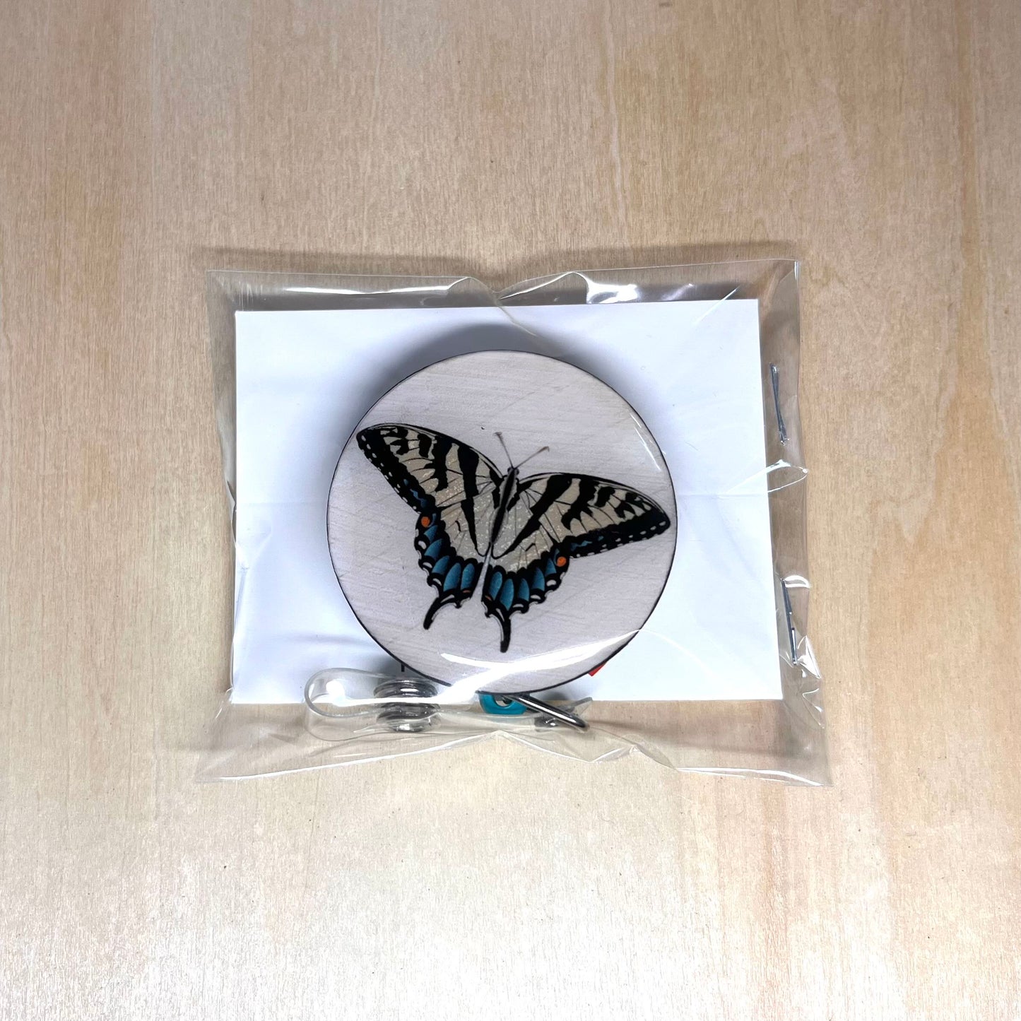 White Striped Black Moth Badge Reel