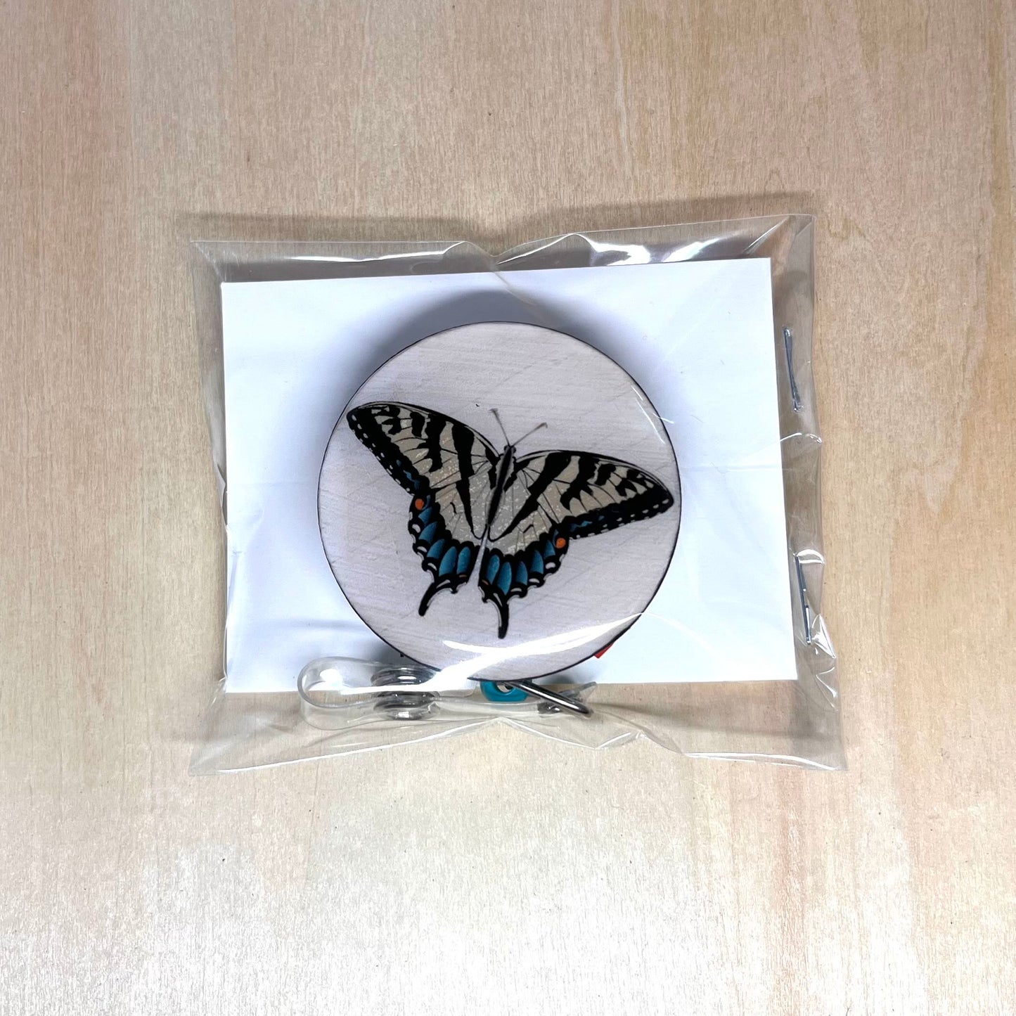 White Striped Black Moth Badge Reel